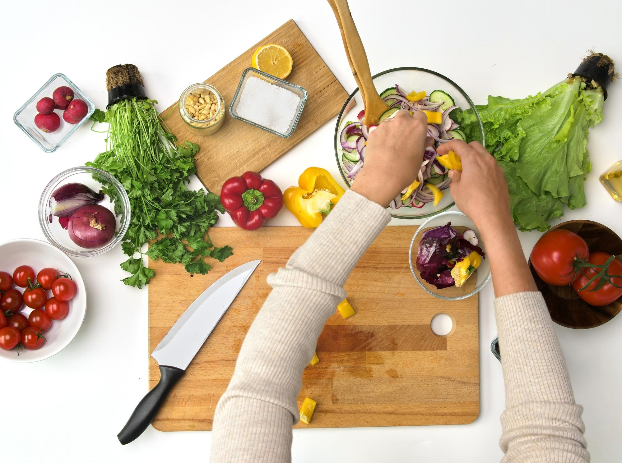 Hands preparing a quick weekday meal in a small kitchen